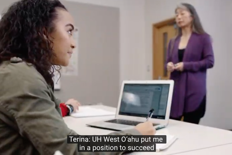 Student sitting at laptop with closed captioning identifying her name.