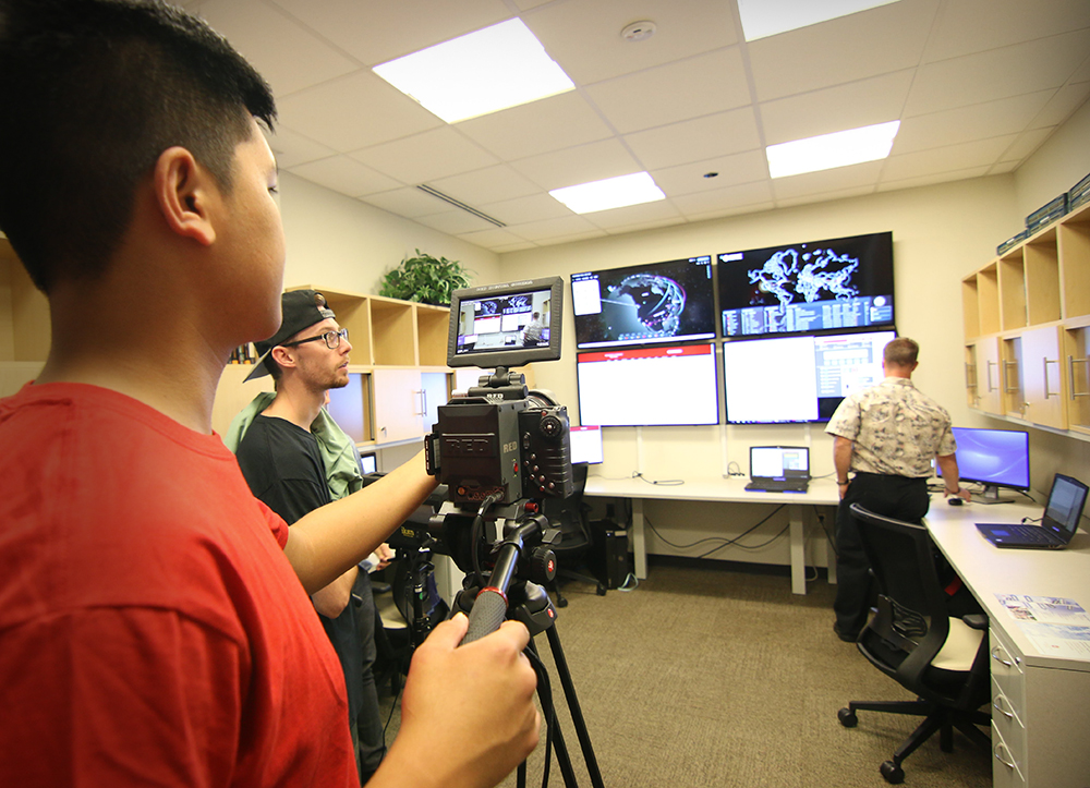 Two Academy of Creative Media students recording action for a campus commercial.