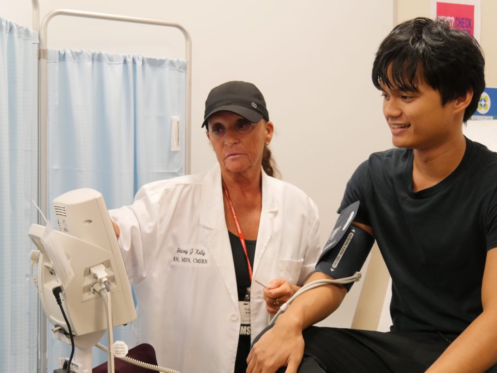 Nurse taking student's blood pressure