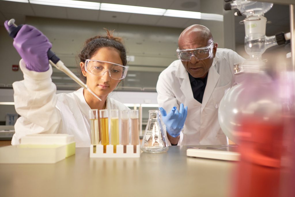 Instructor and Student mixing science beakers