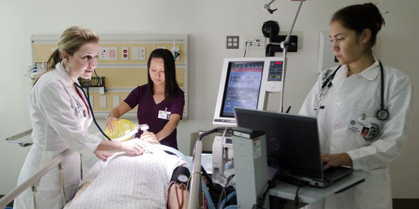 Photo of nurses attending to a patient