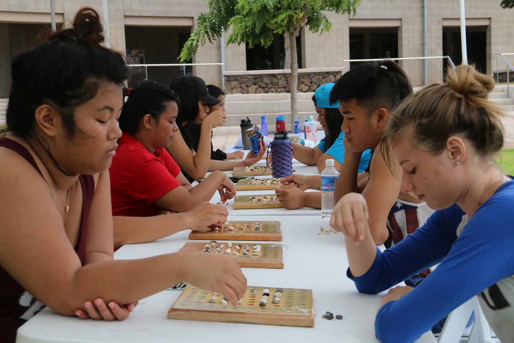 ʻOnipaʻa students playing kōnane during the Summer Bridge program team work and perseverance day.