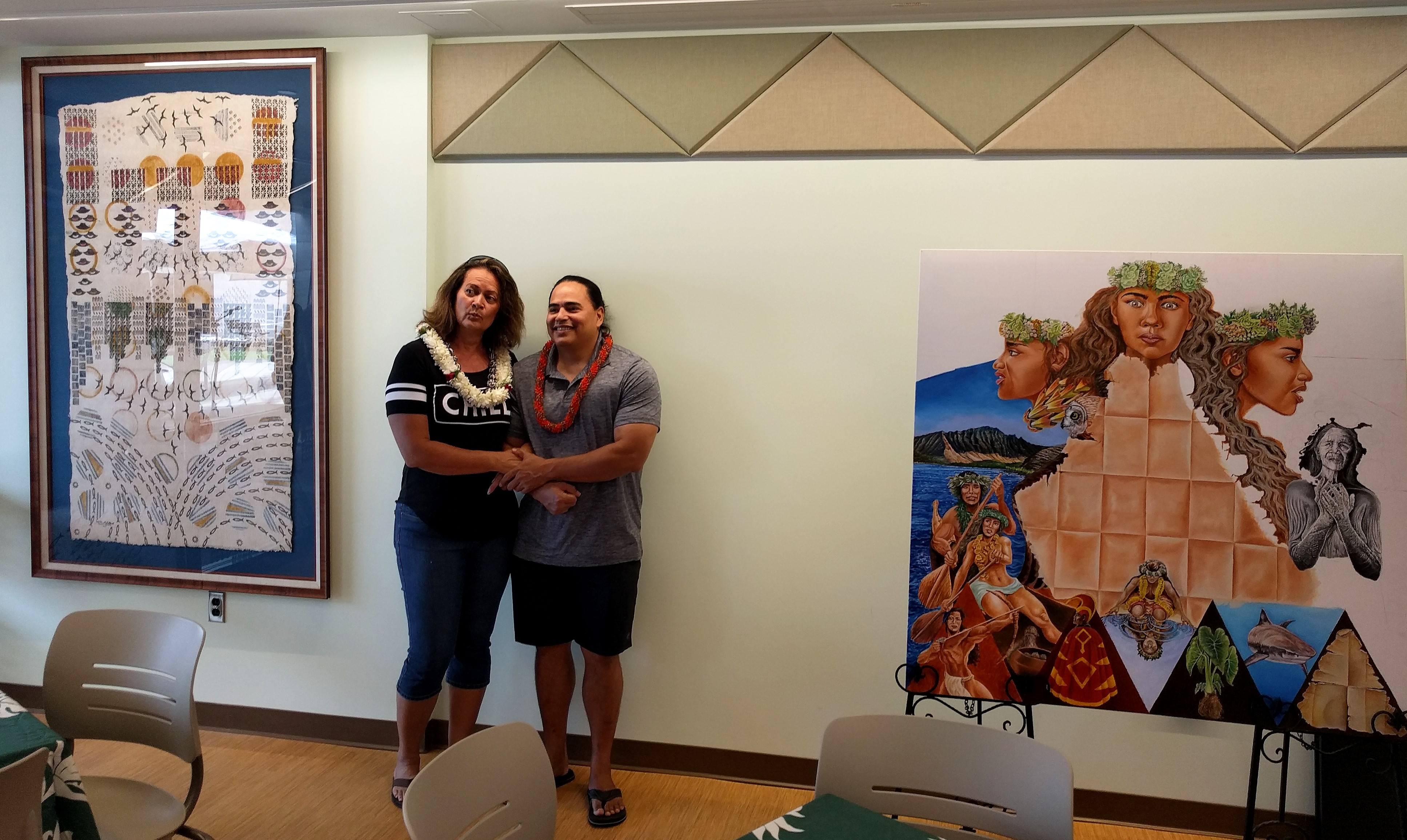 Tanahy (l) and Kupihea pose with their artwork in the Nāulu Center.