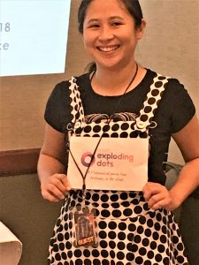 photo of Dr. Veny Liu wearing a polka-dot dress and sign saying Exploding Dots