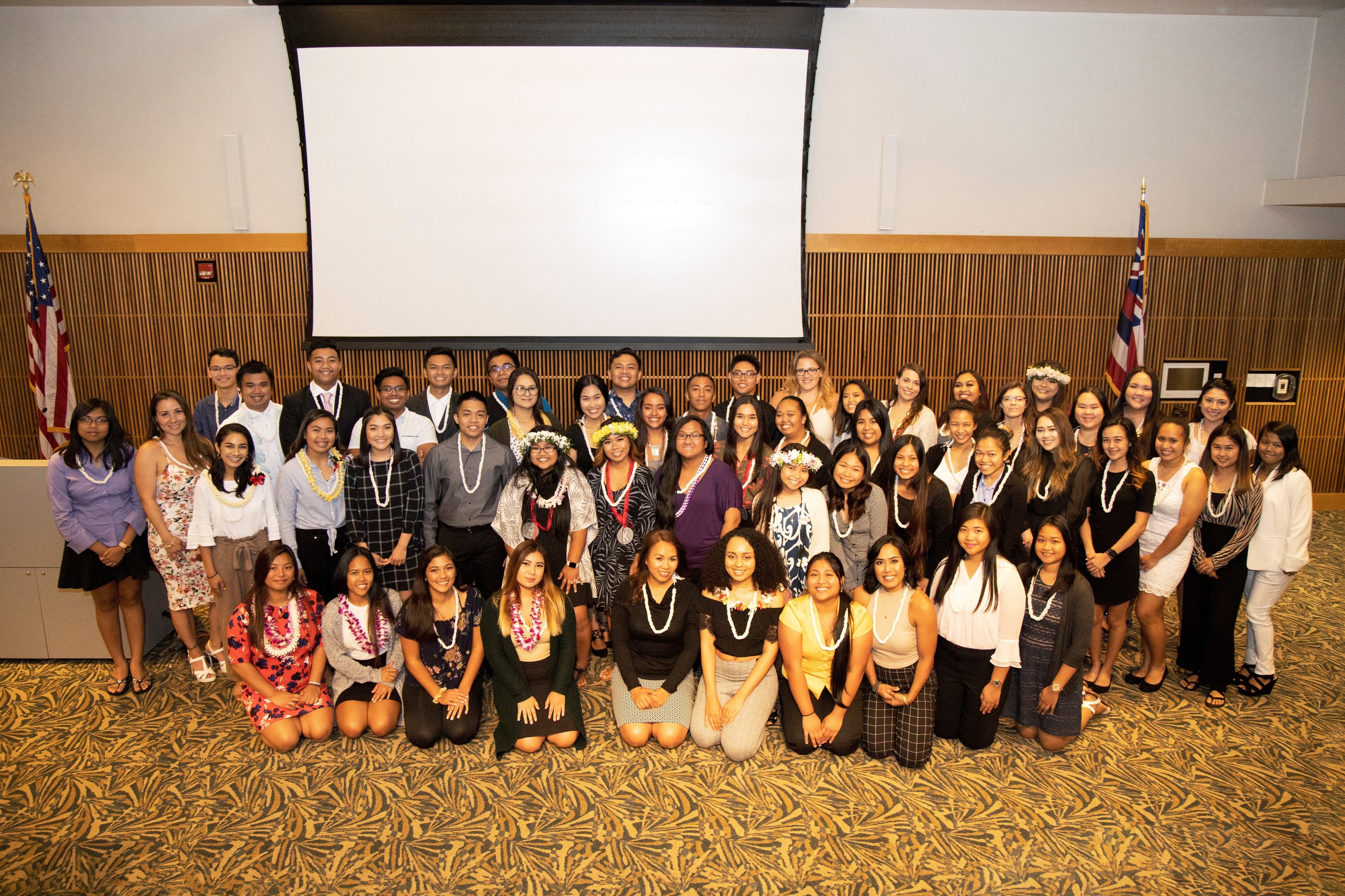 Photo of more than 55 students who are standing and kneeling at the NSLS induction ceremony. The group shot was taken in the Campus Center Multi-Purpose room.