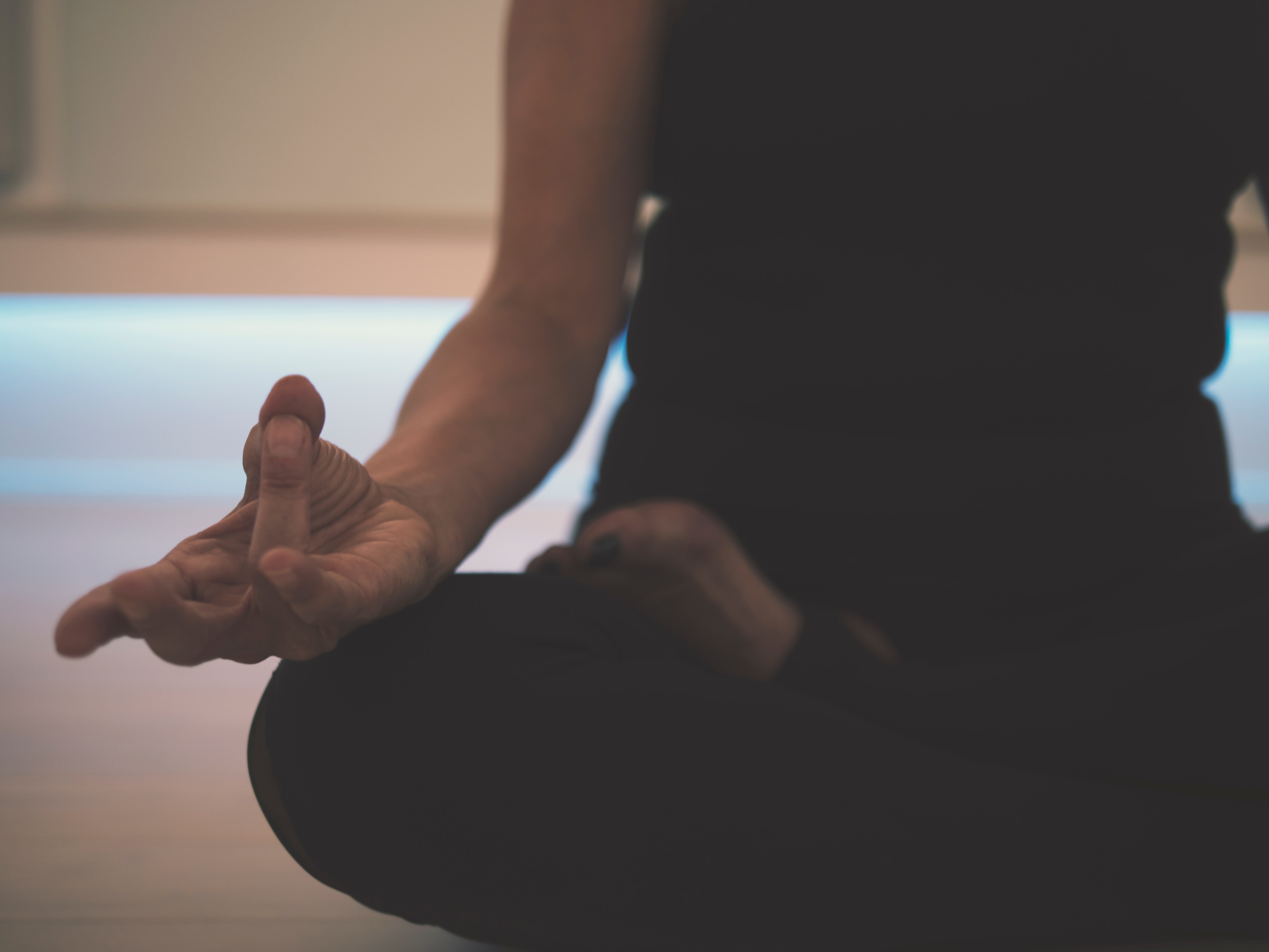 Person doing yoga on floor.