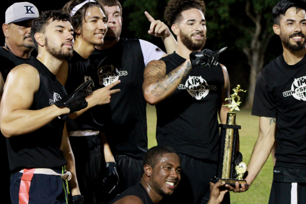 Football players pose for a group photo after winning league championship
