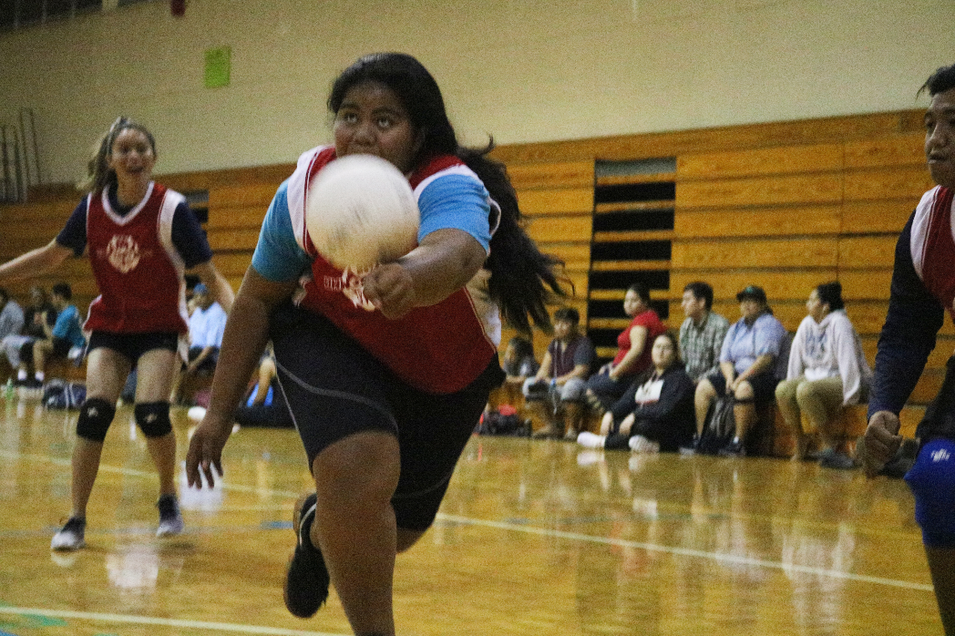 A student hitting a volleyball