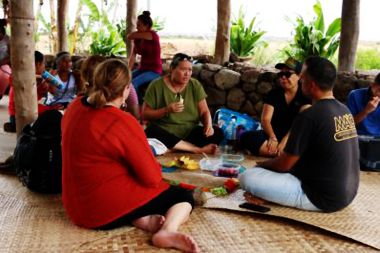 people sitting on a mat