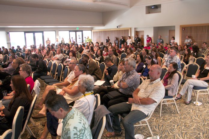 An audience of UH West Oʻahu faculty and staff listen to a presentation.