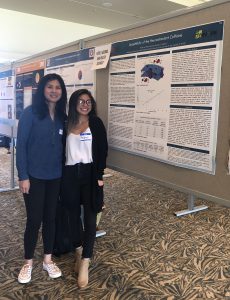 Two students standing in front of their research poster.