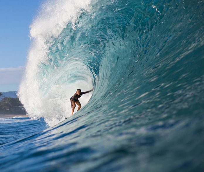 Moanalani Jones Wong surfing in a wave barrel.