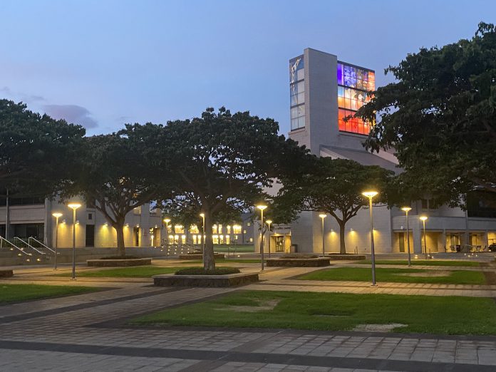 The U H West Oahu library tower lit up at dusk.