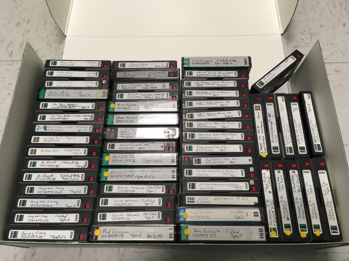 A box of dozens of labeled videotapes.
