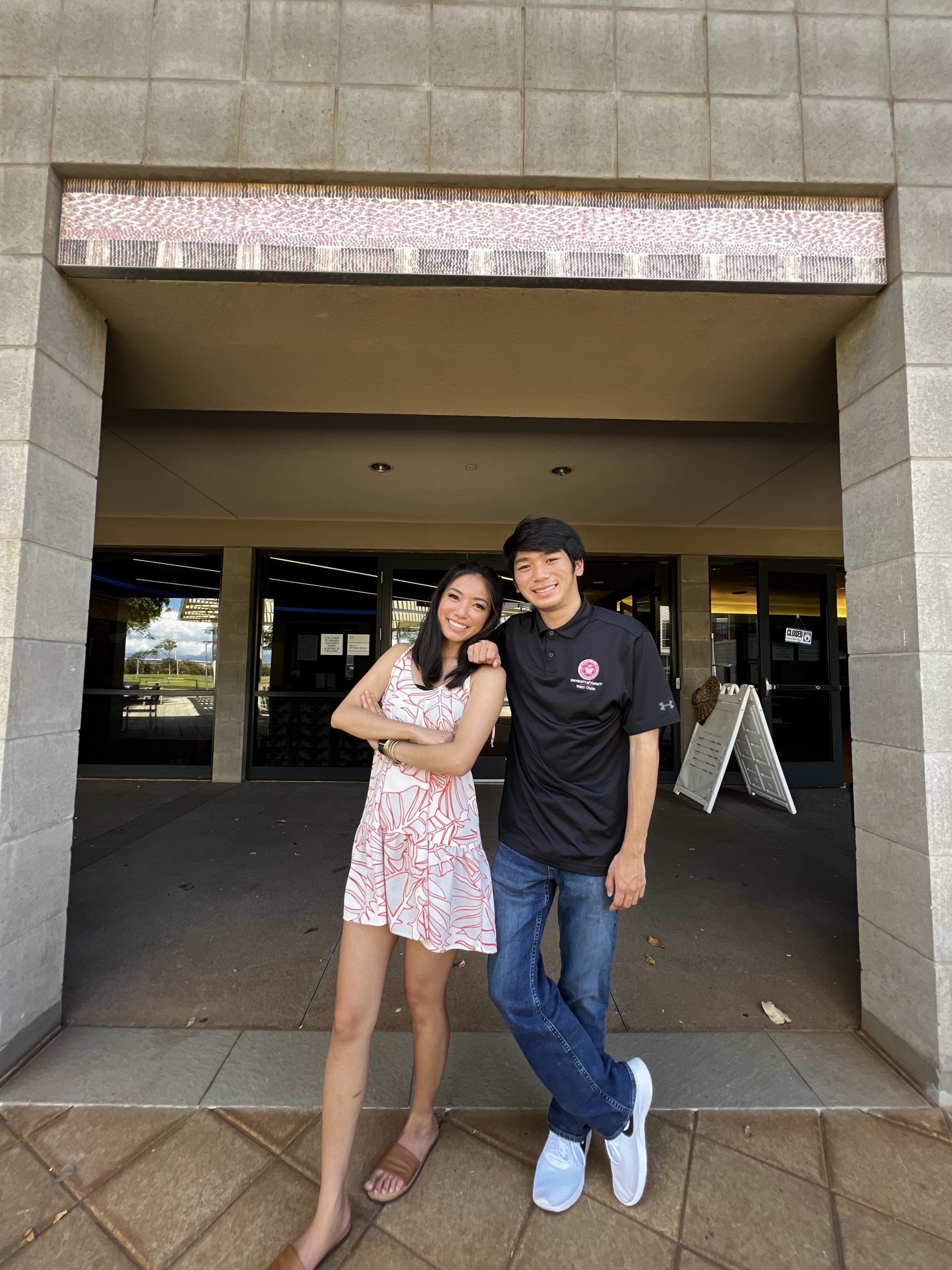 A sister and her brother standing on campus at U H West Oahu.