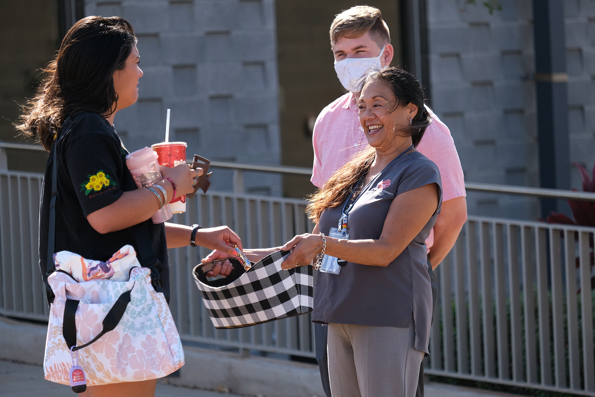 Chancellor Benham greets a student near the campus entrance on the second day of the Fall 2023 semester.