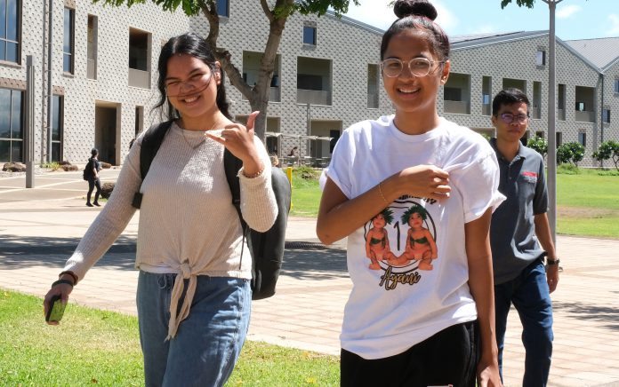Three students walking outdoors at the UH West Oahu campus.