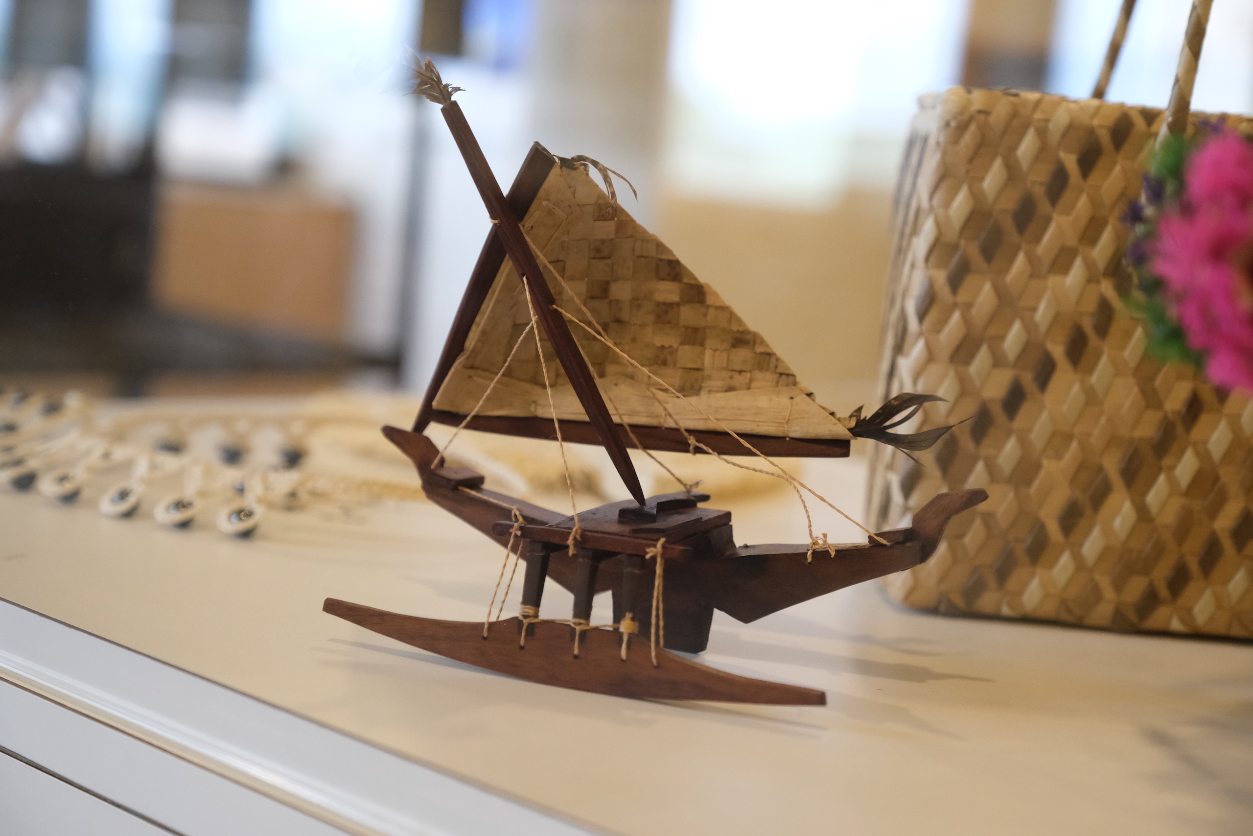 Wooden carving of a miniature canoe.