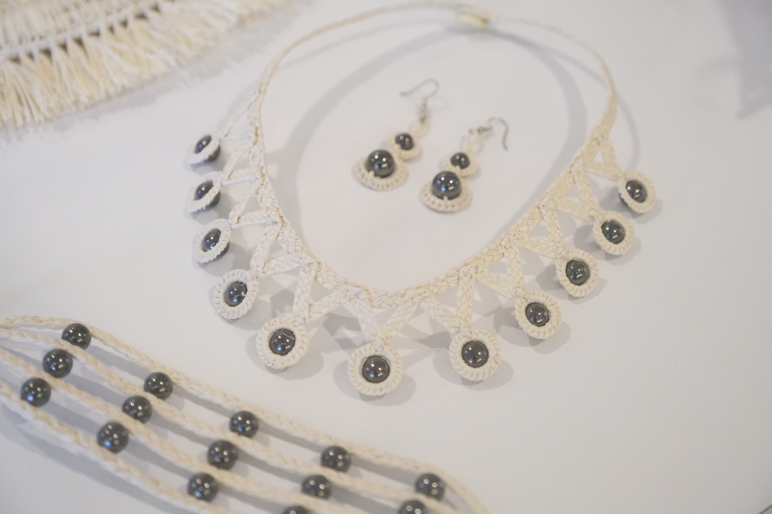 A set of jewelry, including earrings and a necklace.