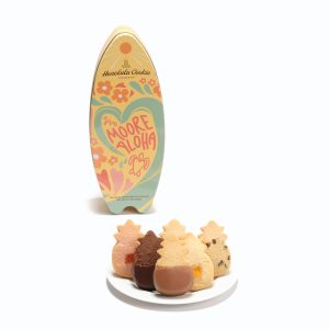 A surfboard-shaped cookie tin and a plate of five pineapple-shaped cookeis.