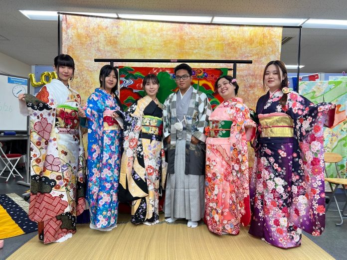 A group of people dressed in colorful Japanese kimonos.