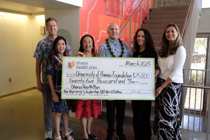 A group of men and women holding a large check.