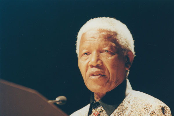 A picture of Nelson Mandela speaking into a microphone