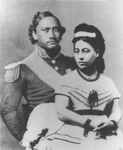 A portrait of Queen Emma, with Kamehameha IV standing behind her.