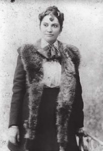 A picture of Kini Kapahu Wilson, standing in a coat.
