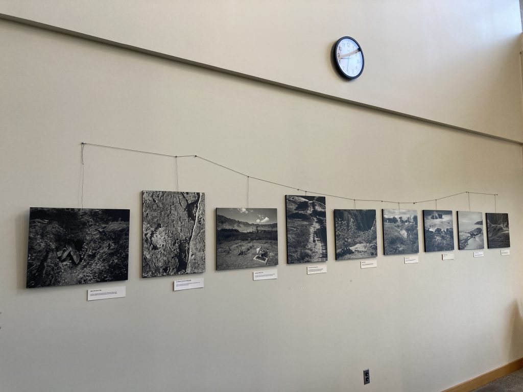 An image of some of the artwork related to the Kānehūnāmoku Exhibit showcasing several framed pieces of art on a wall.