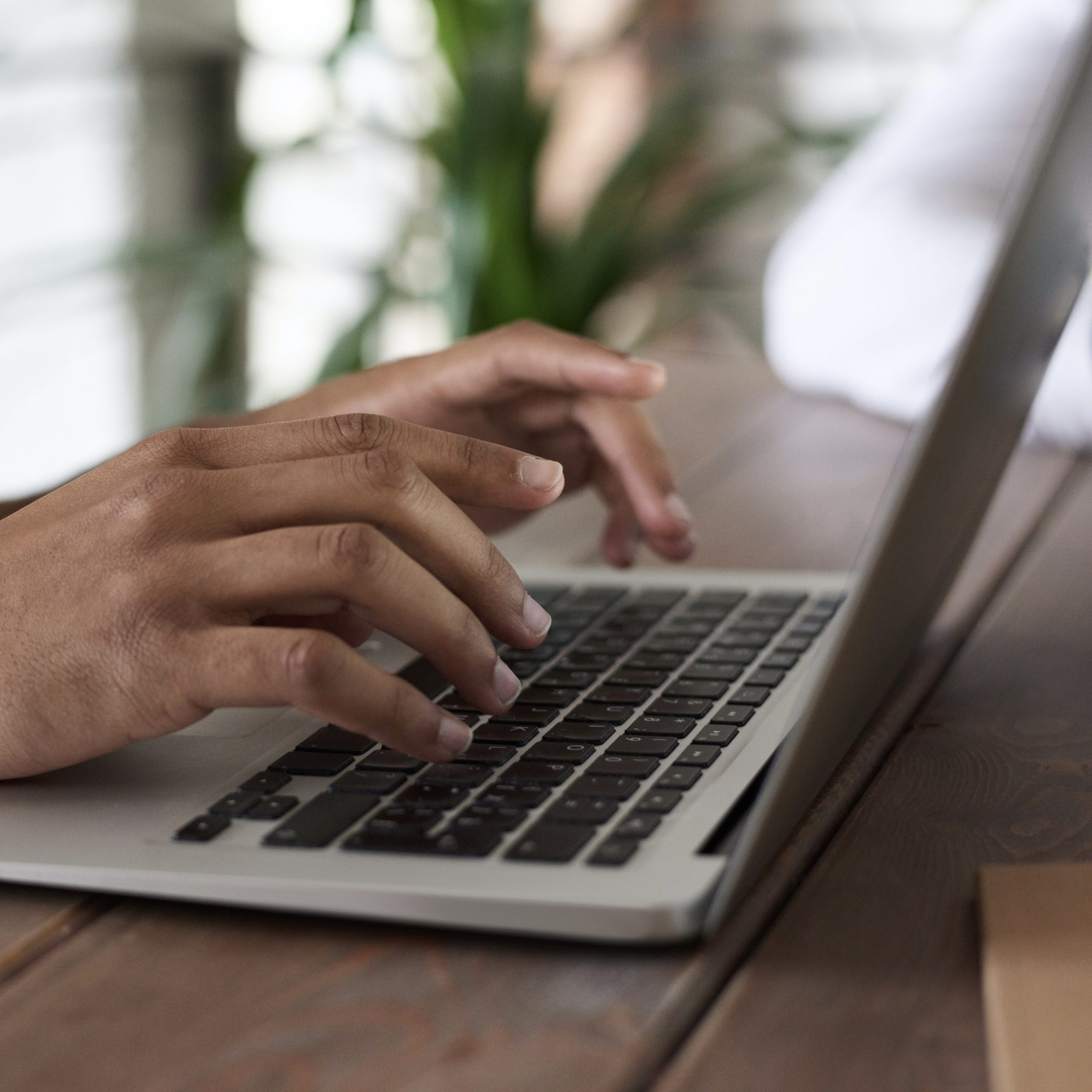 Closeup of fingers typing on a laptop.