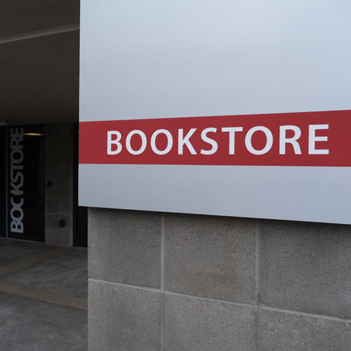 Signage on a pillar fronting the new bookstore location near the front of campus.