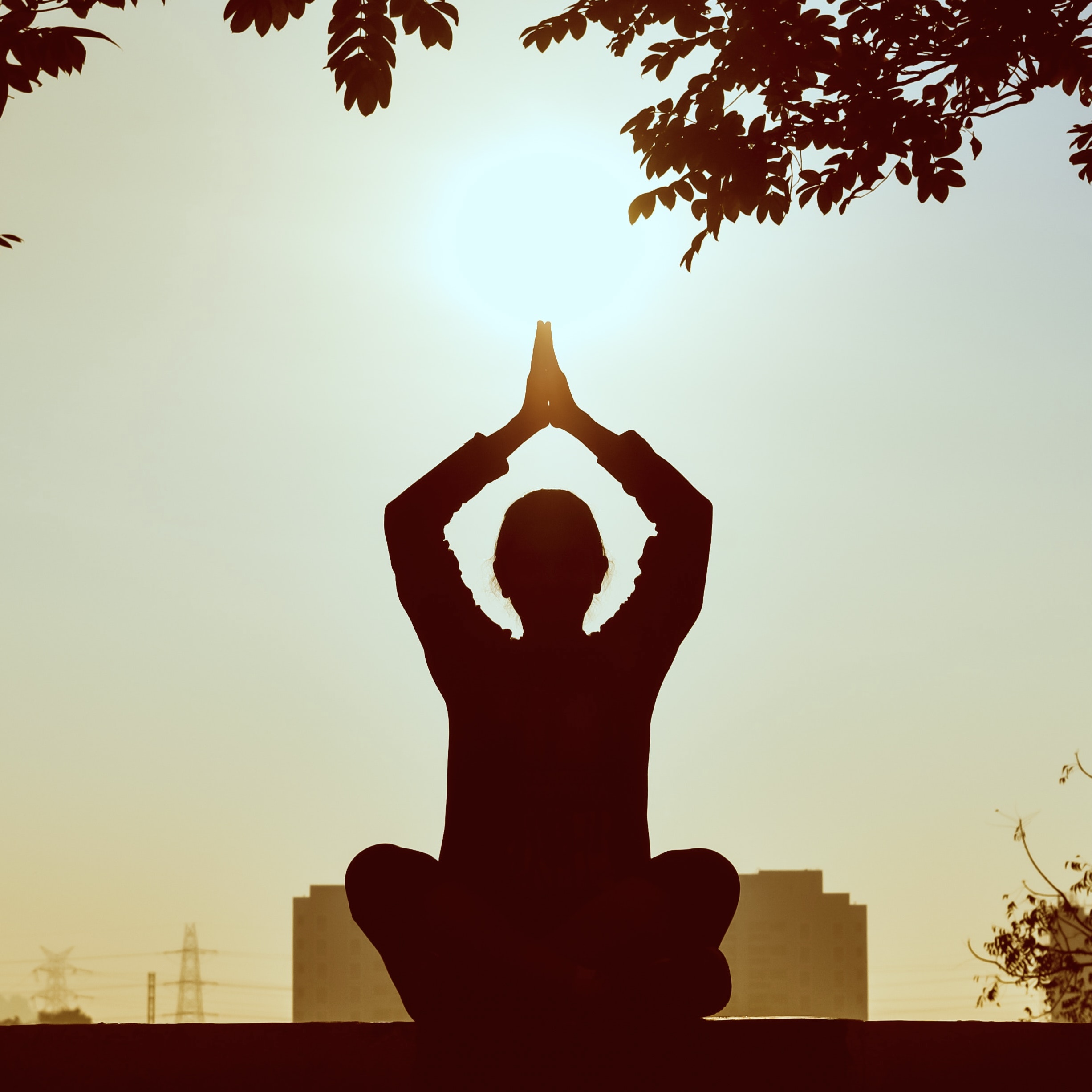 Silhouette of a person doing yoga.
