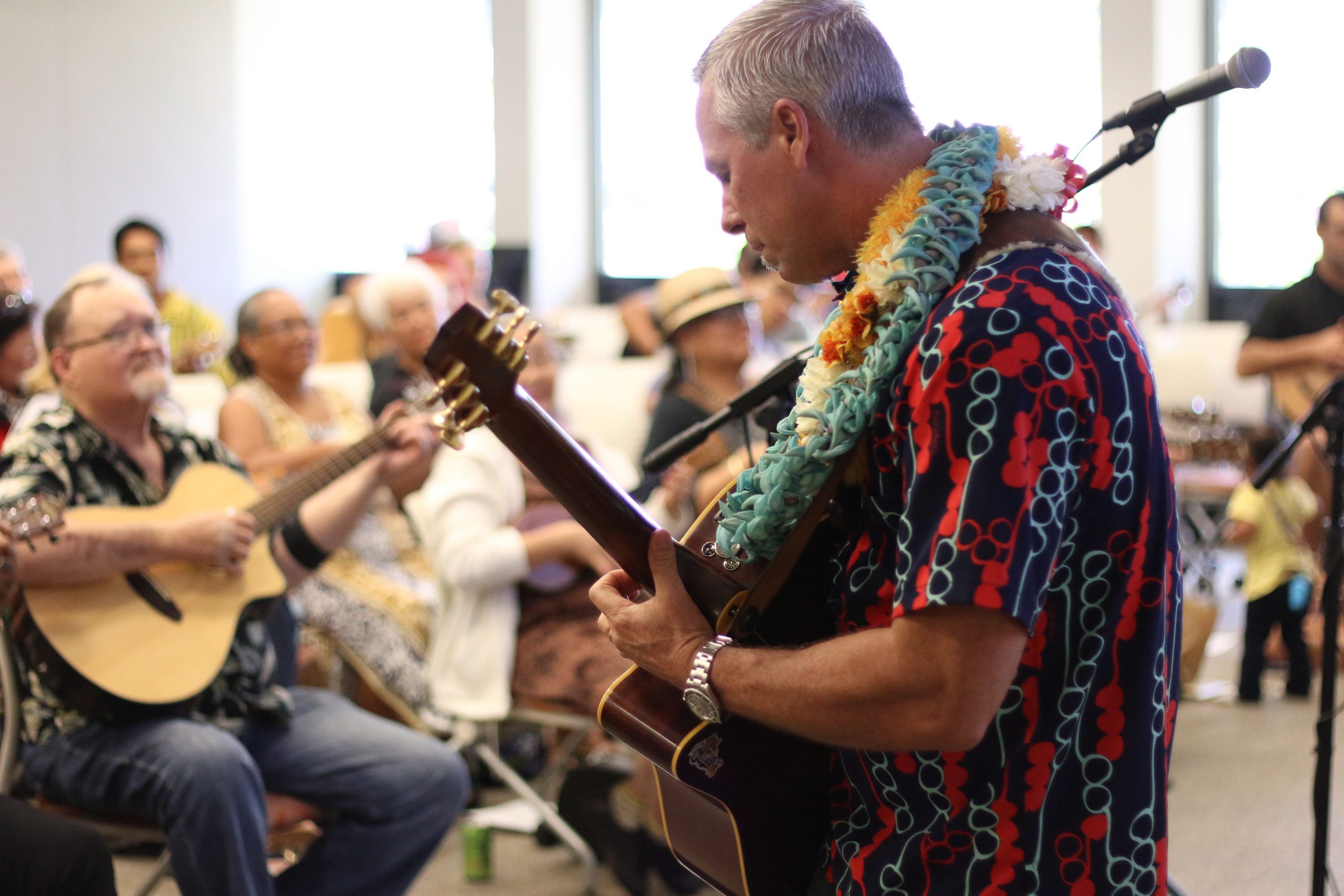Bobby Moderow playing guitar at a Ho'okani Kulanui event.