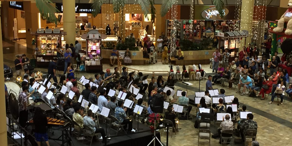 University Band performs a community concert at Windward Mall, co-directed by Chadwick Kamei and Michael Nakasone.
