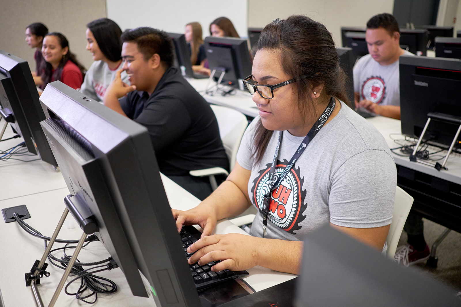 Students sitting in front of desktop computers.