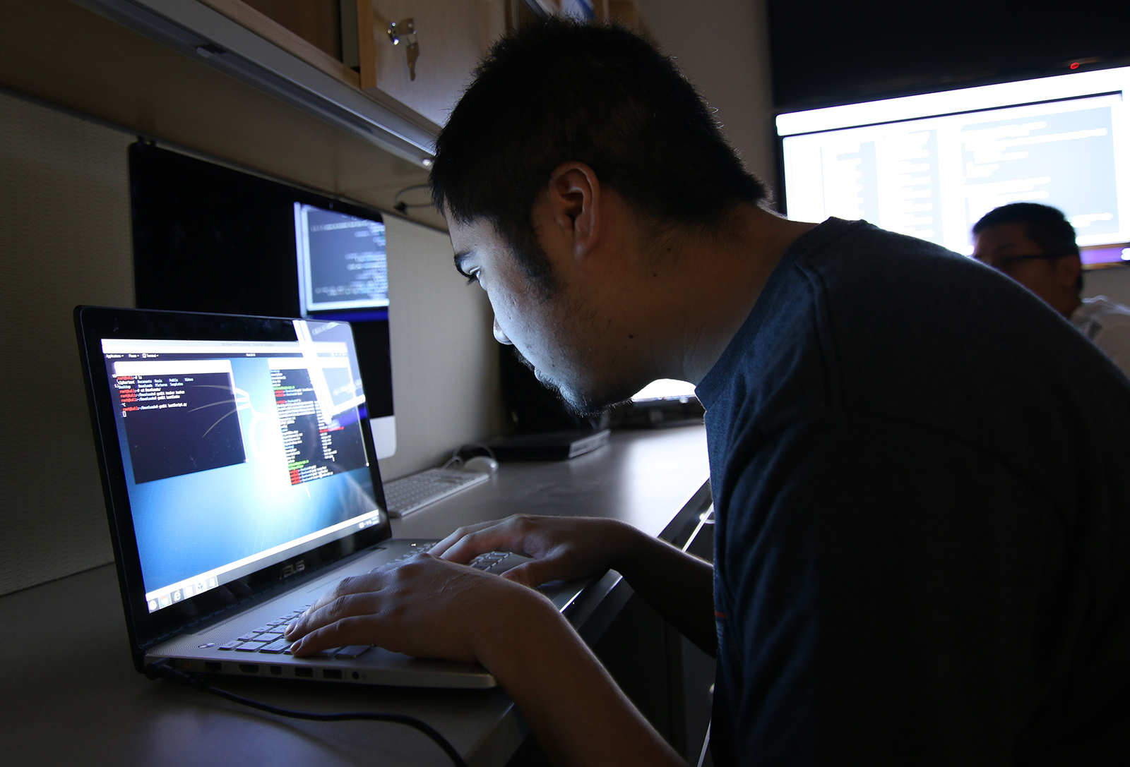 Student sitting in front of laptop in the dark.