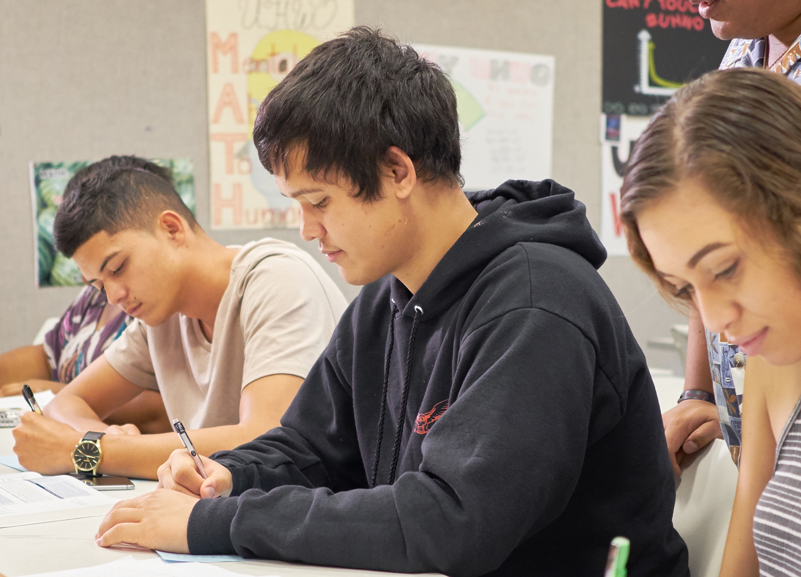 Students writing in a classroom.