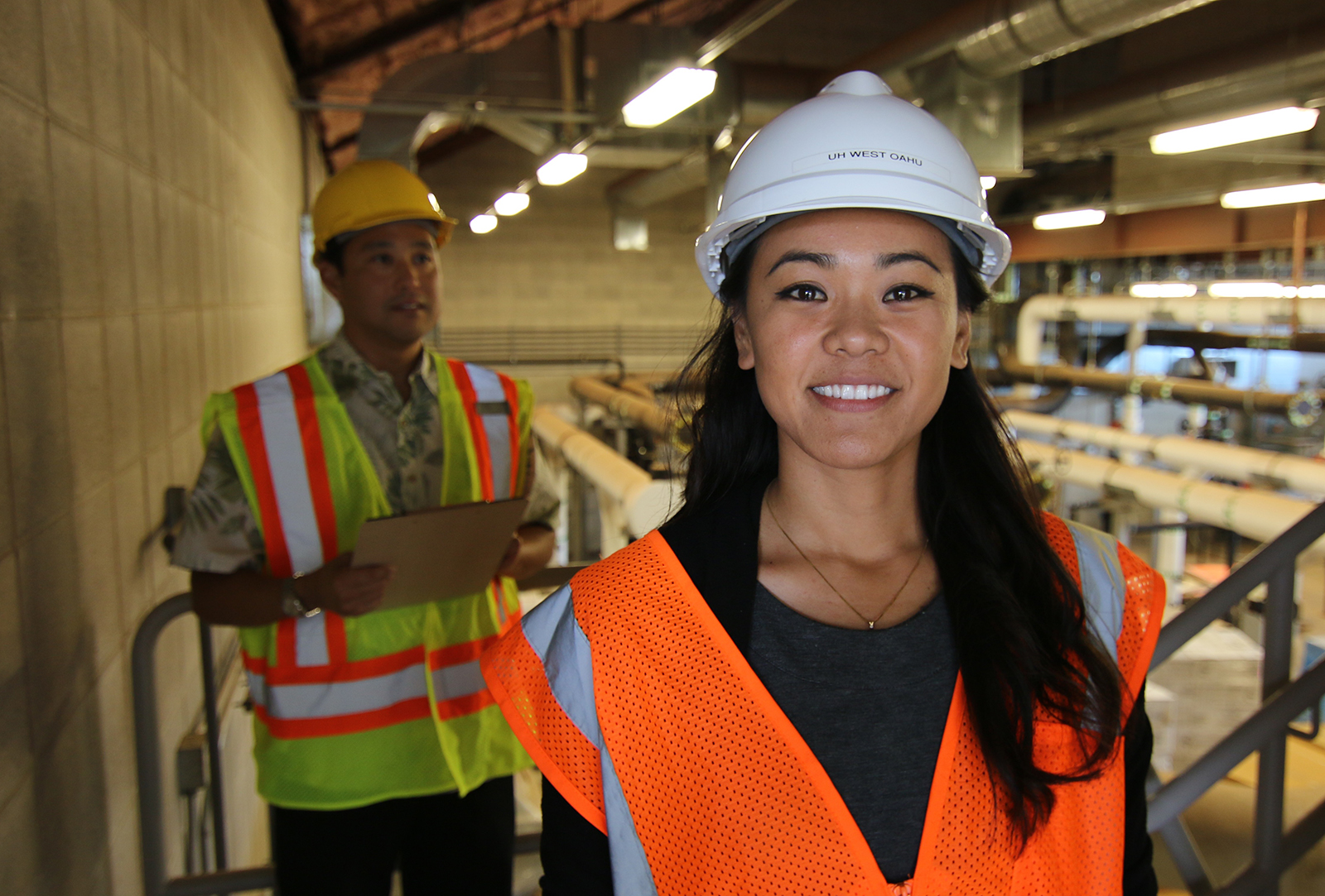 Facilities Management student standing in an industrial scene.