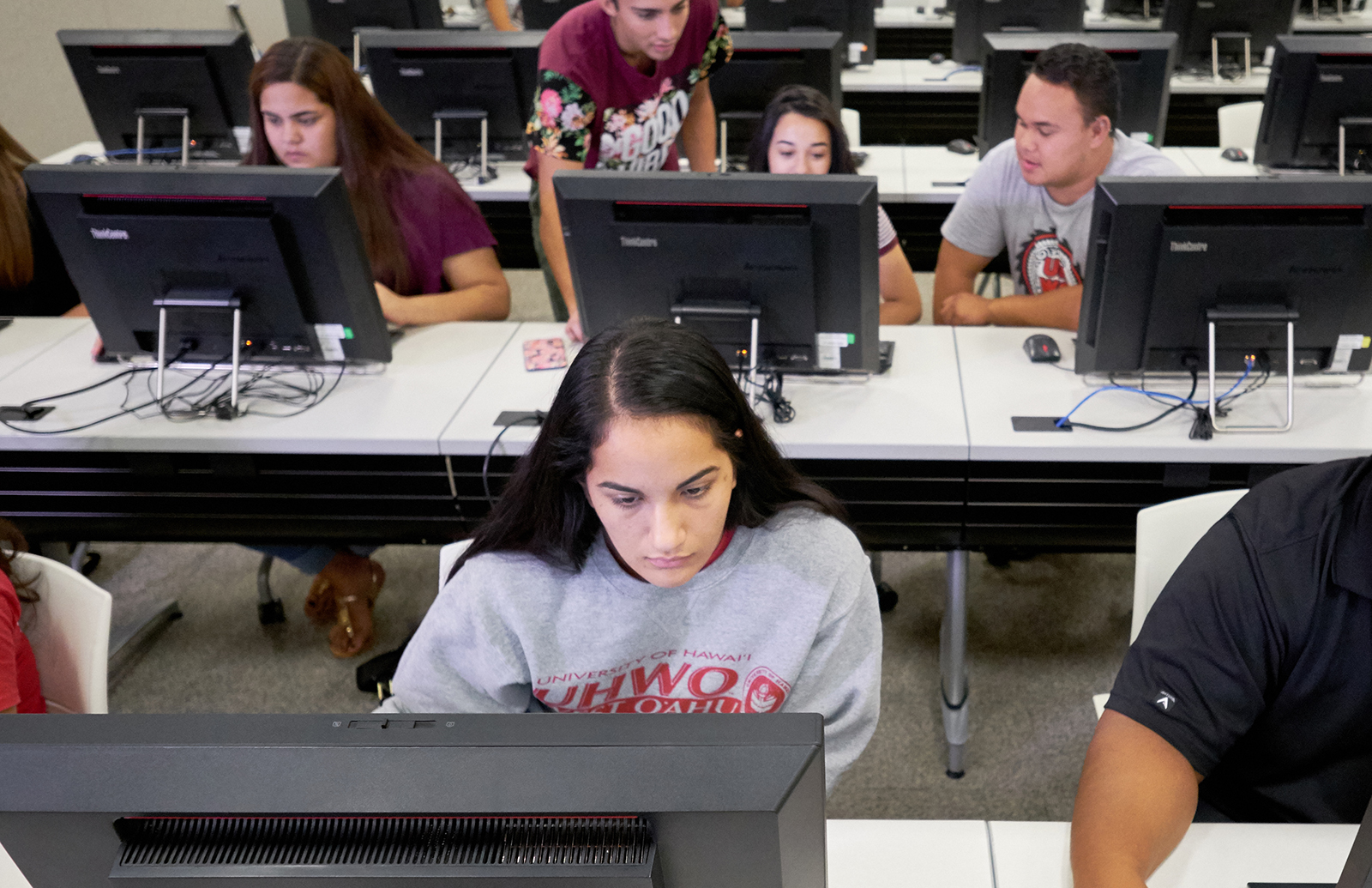 Students sitting in front of desktop computers.