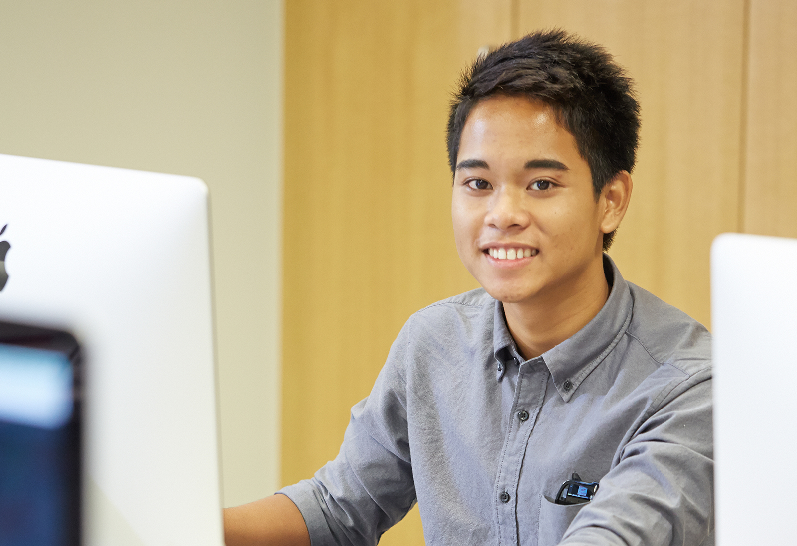 Student sitting in front of a desktop computer.