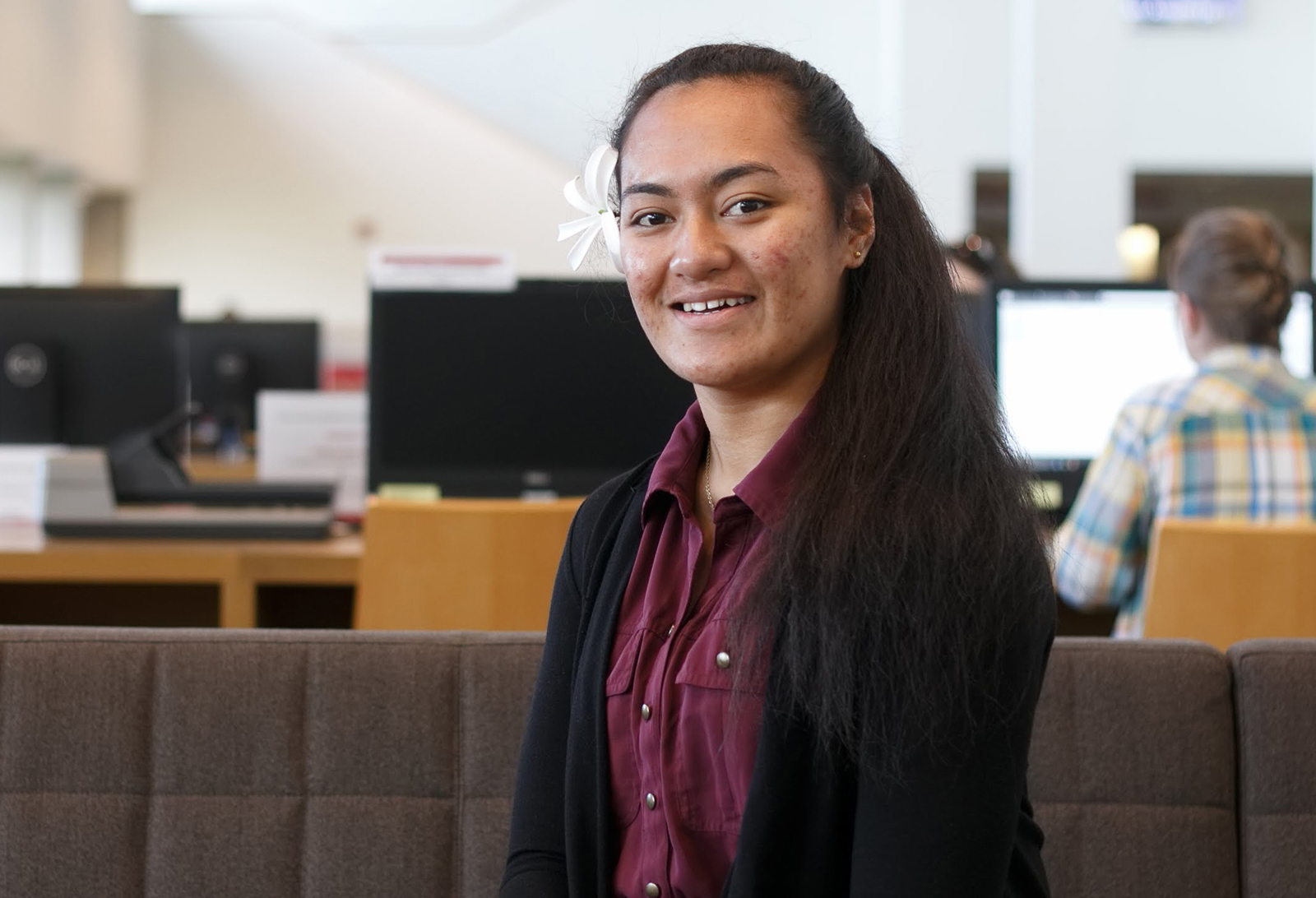 Student smiling while sitting.