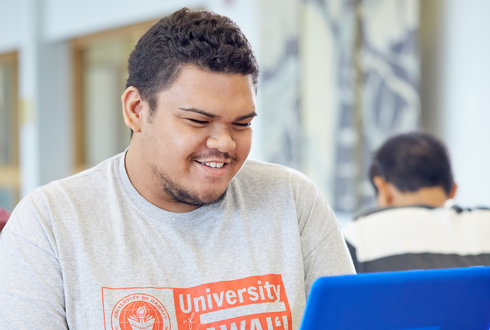 Student sitting in front of a laptop computer.